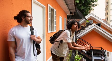 Two students looking out from a balcony